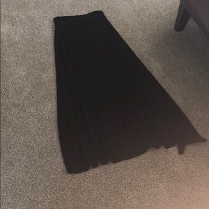 Ankle length black skirt.